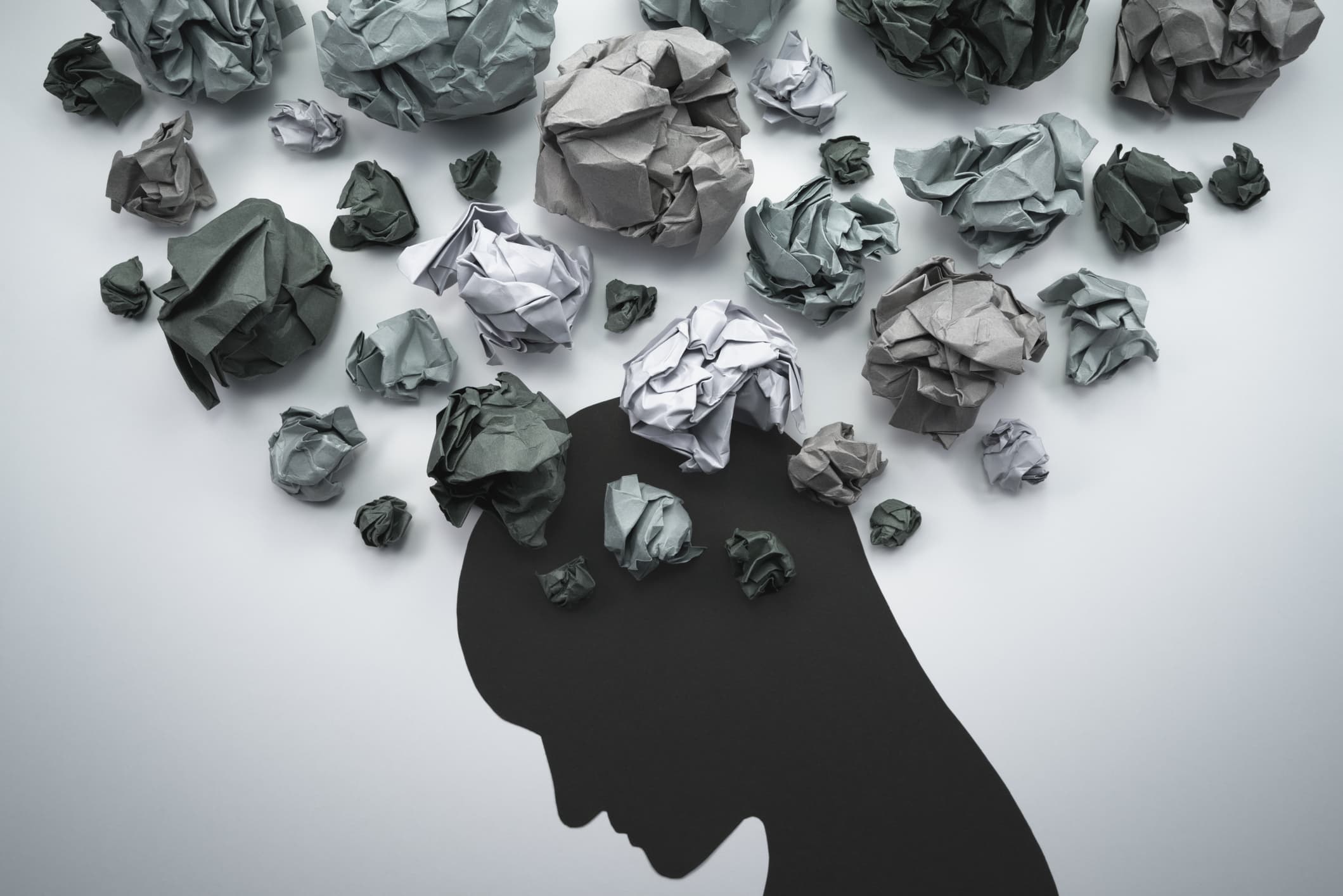 Concept image of anxiety and depression cartoon head with scrunched up paper around it indicating that this person may have a psychological injury