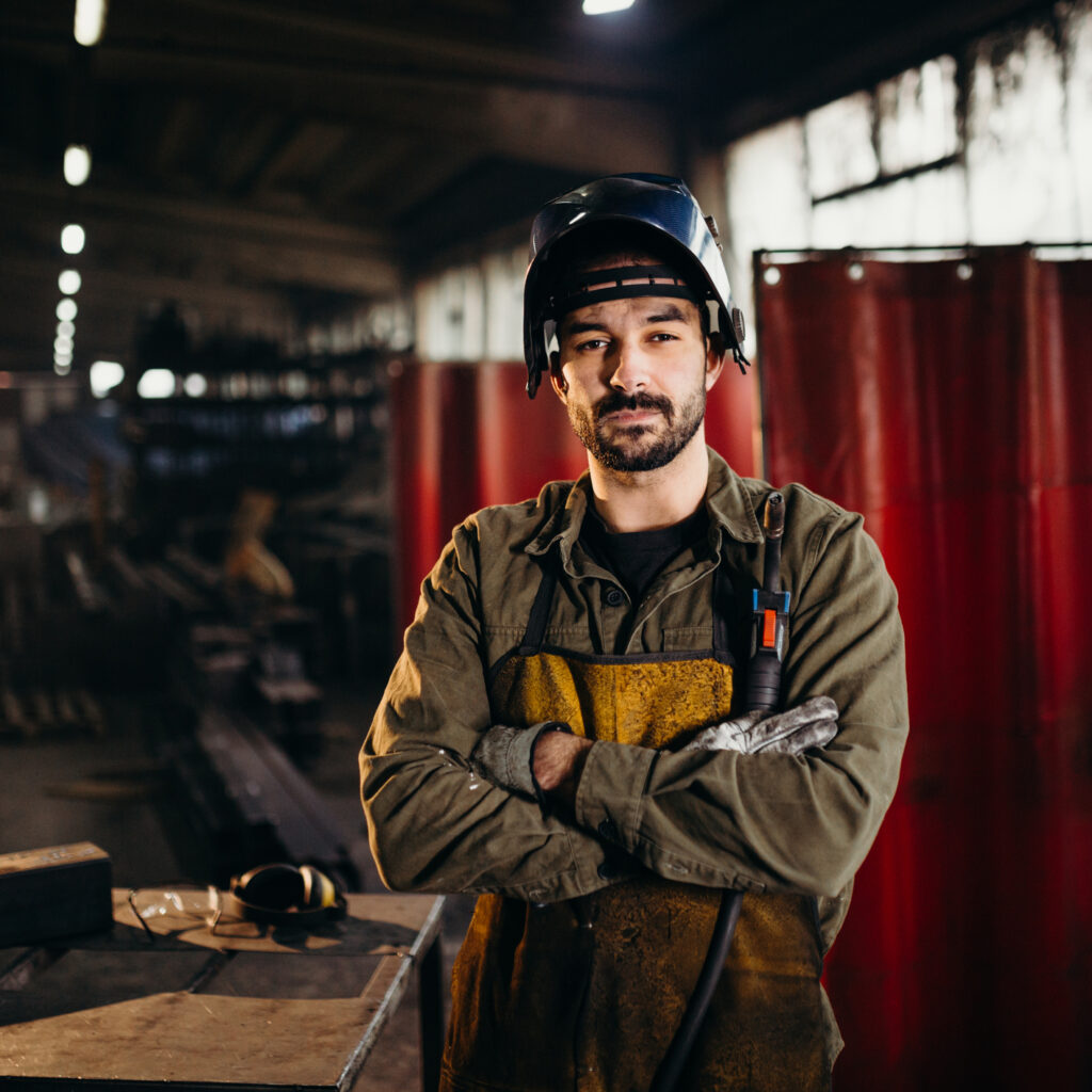 Male welder working in factory