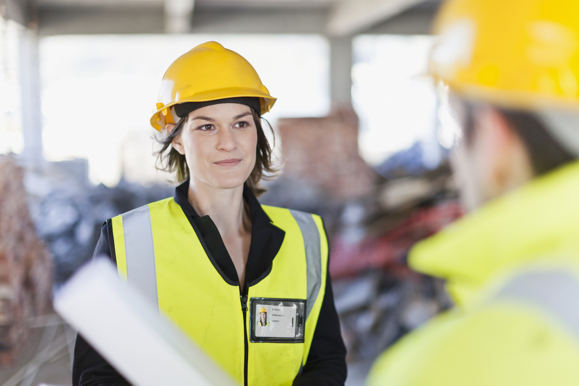 Female work safety specialist attending work site to check work safe requirements