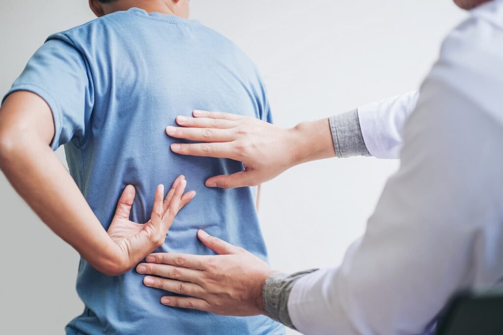 Doctor consulting with patient back problems