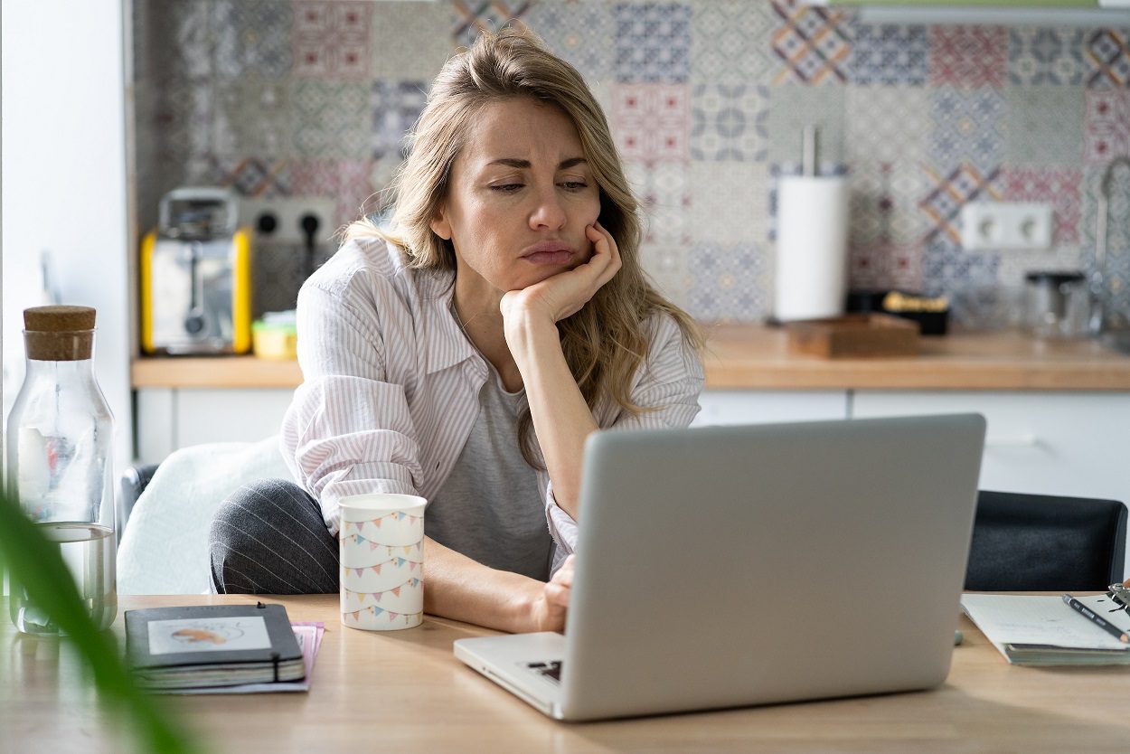 Woman working from a makeshift home office in her kitchen